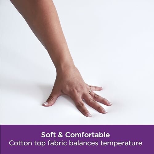 Hand touching a flat white surface with text about cotton fabric.