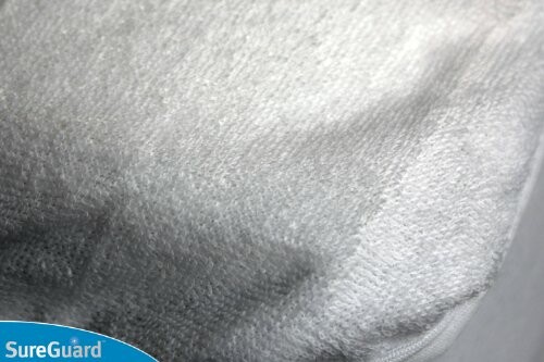 Close-up of waterproof mattress protector with SureGuard logo.